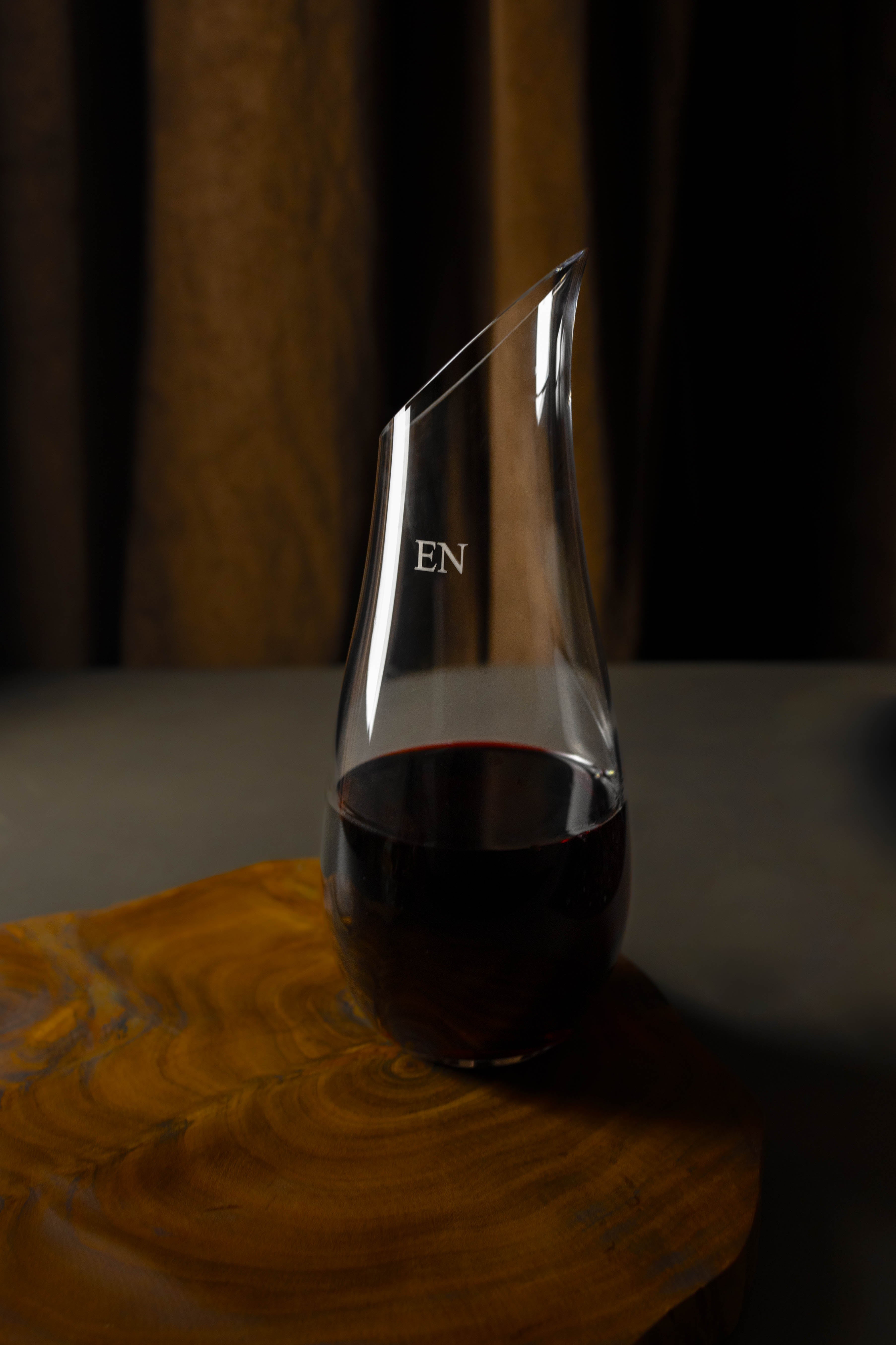 Wine and water carafe engraved with initials on top of a wooden platter