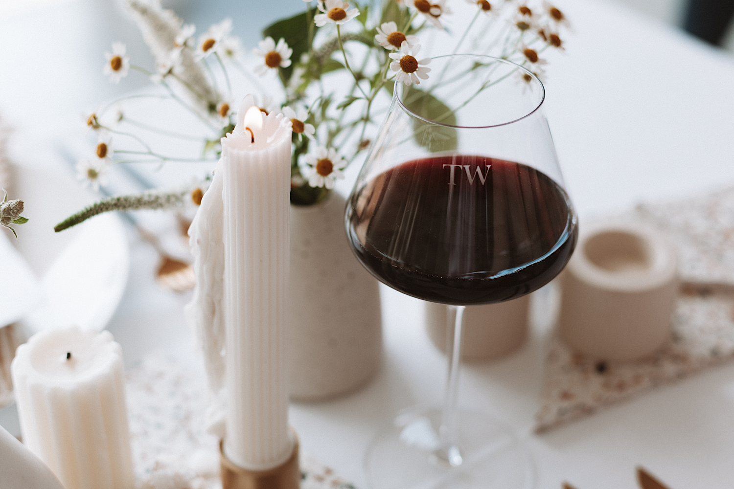 A dinner table with a red wine glass