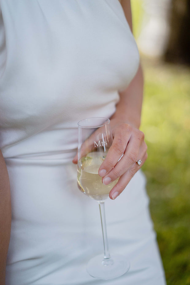 Bride with wedding ring holding engraved personalised champagne flute